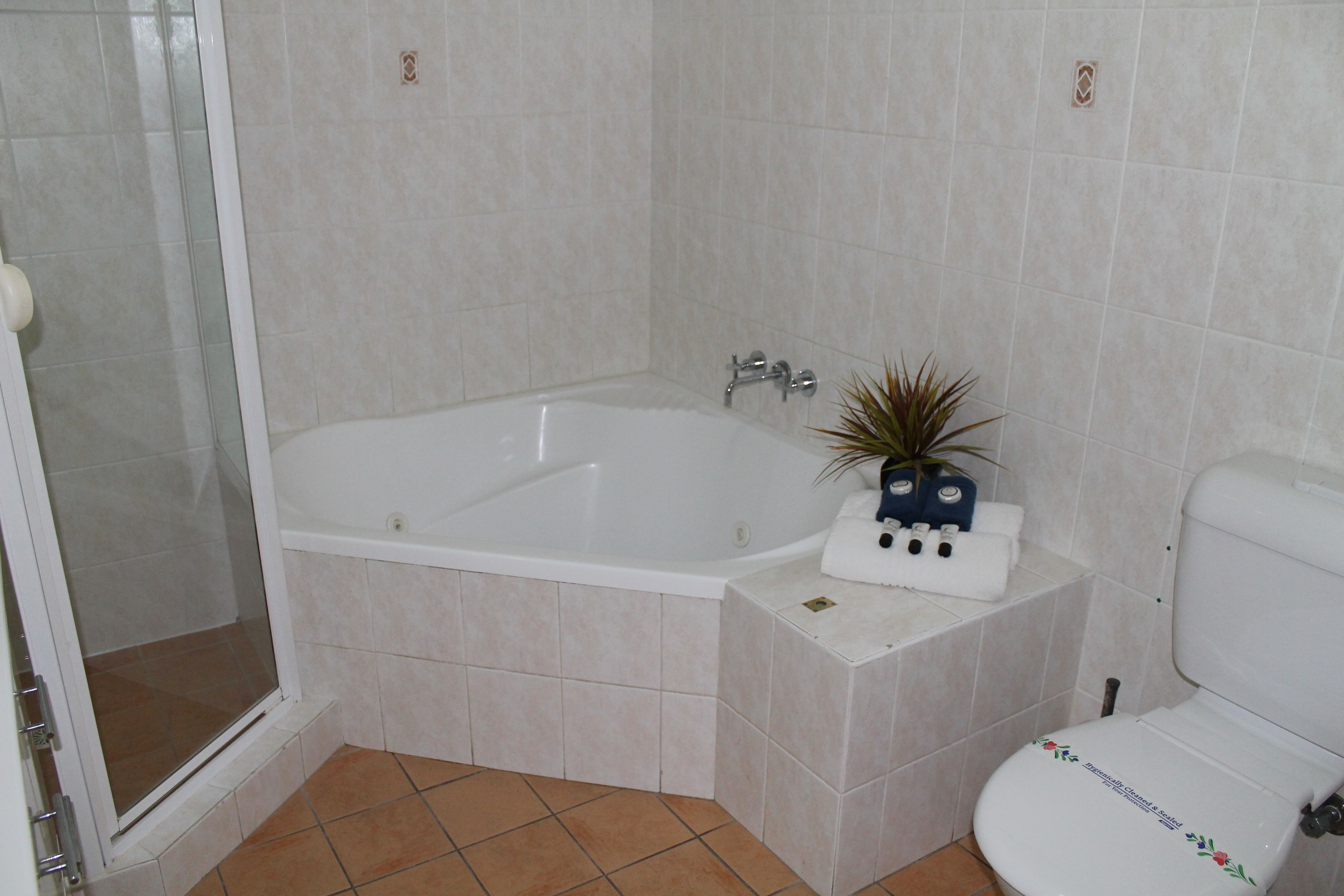 A bathroom with a bathtub, toilet, and shower.