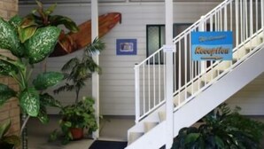 A staircase with a sign indicating a reception area.