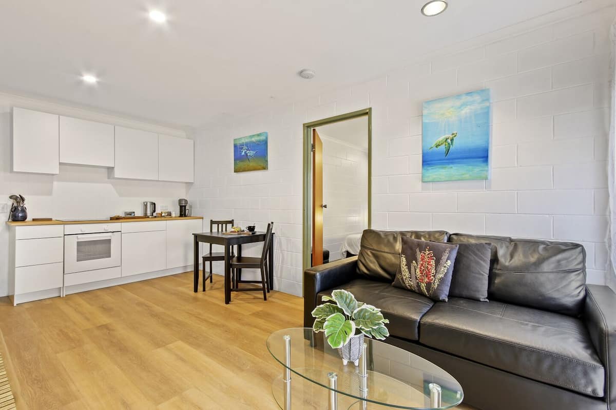 A modern apartment with a kitchen, dining area, and living room.