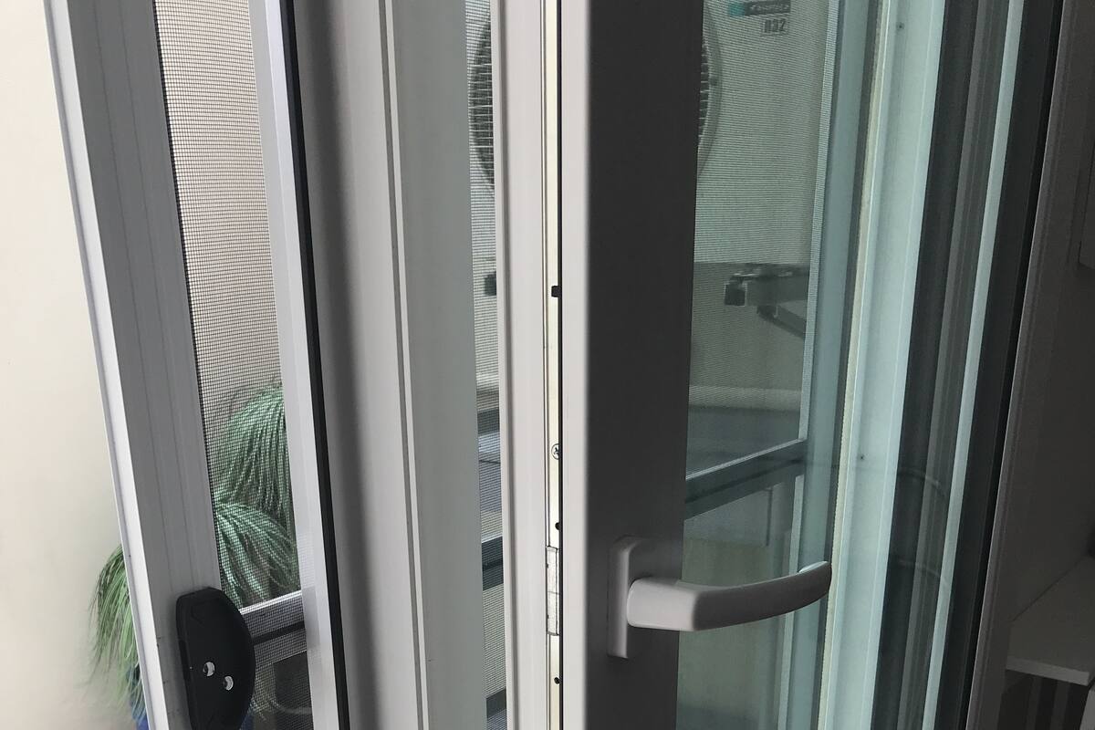 A sliding glass door with a metal handle and a key lock.