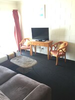 Desk, iron/ironing board, bed sheets