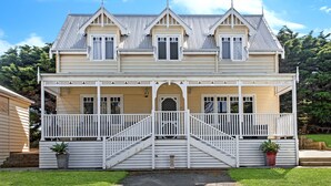 A two-story house with a front porch, a central staircase, and a small front yard. - Dunes - elegant beach villa with huge swim spa (Port Fairy)