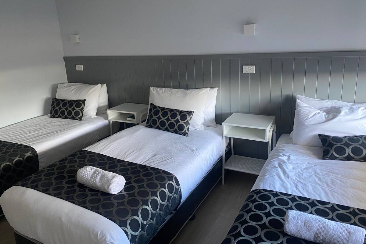 Family Room with King + 3 Single Beds + Kitchenette | Iron/ironing board, WiFi (free), individually decorated, bed sheets