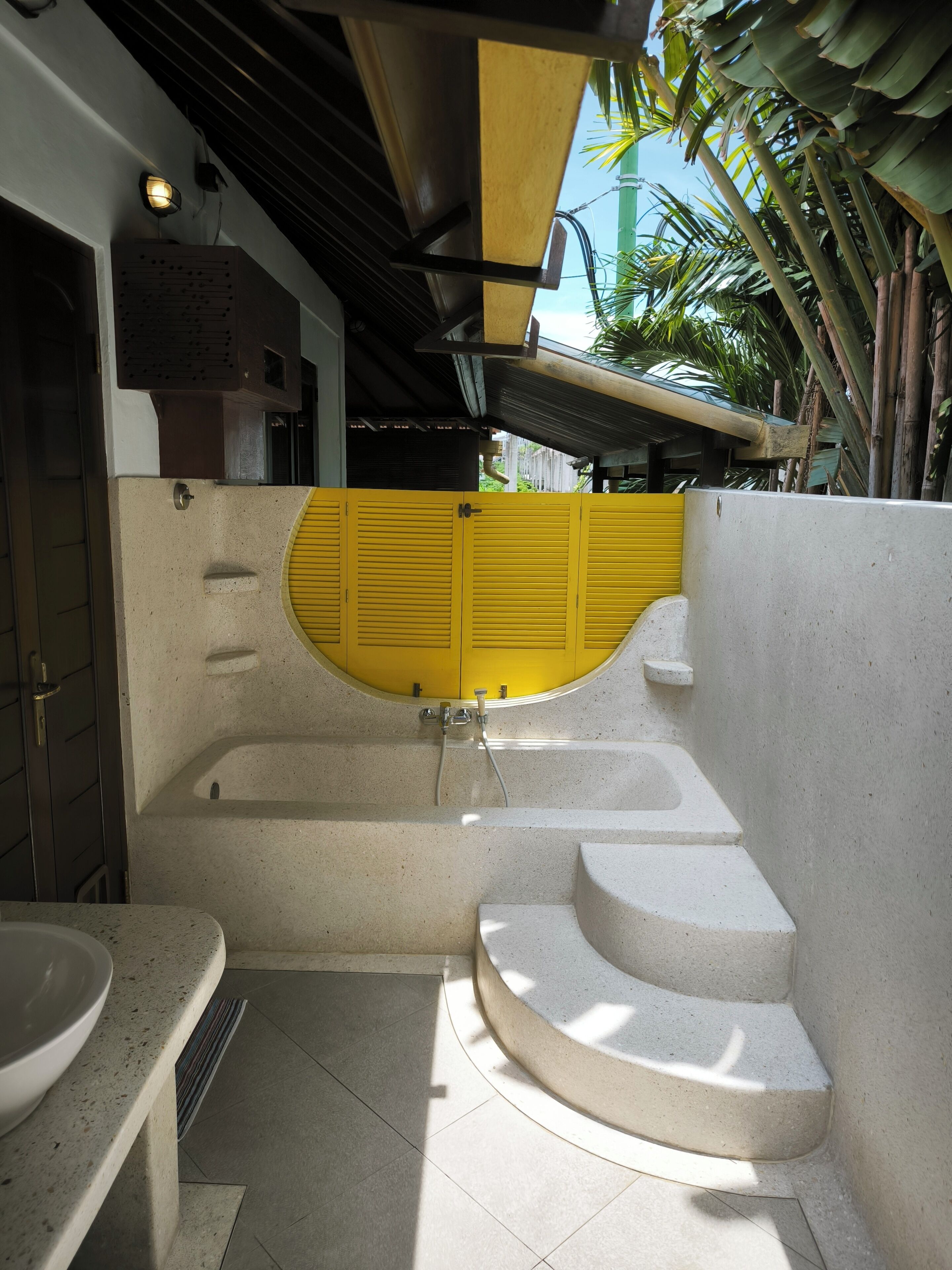 A modern bathroom with a freestanding bathtub, a toilet, and a sink.