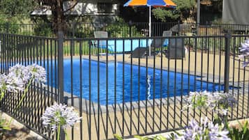 Seasonal outdoor pool, open 8:00 AM to 8:00 PM, pool umbrellas