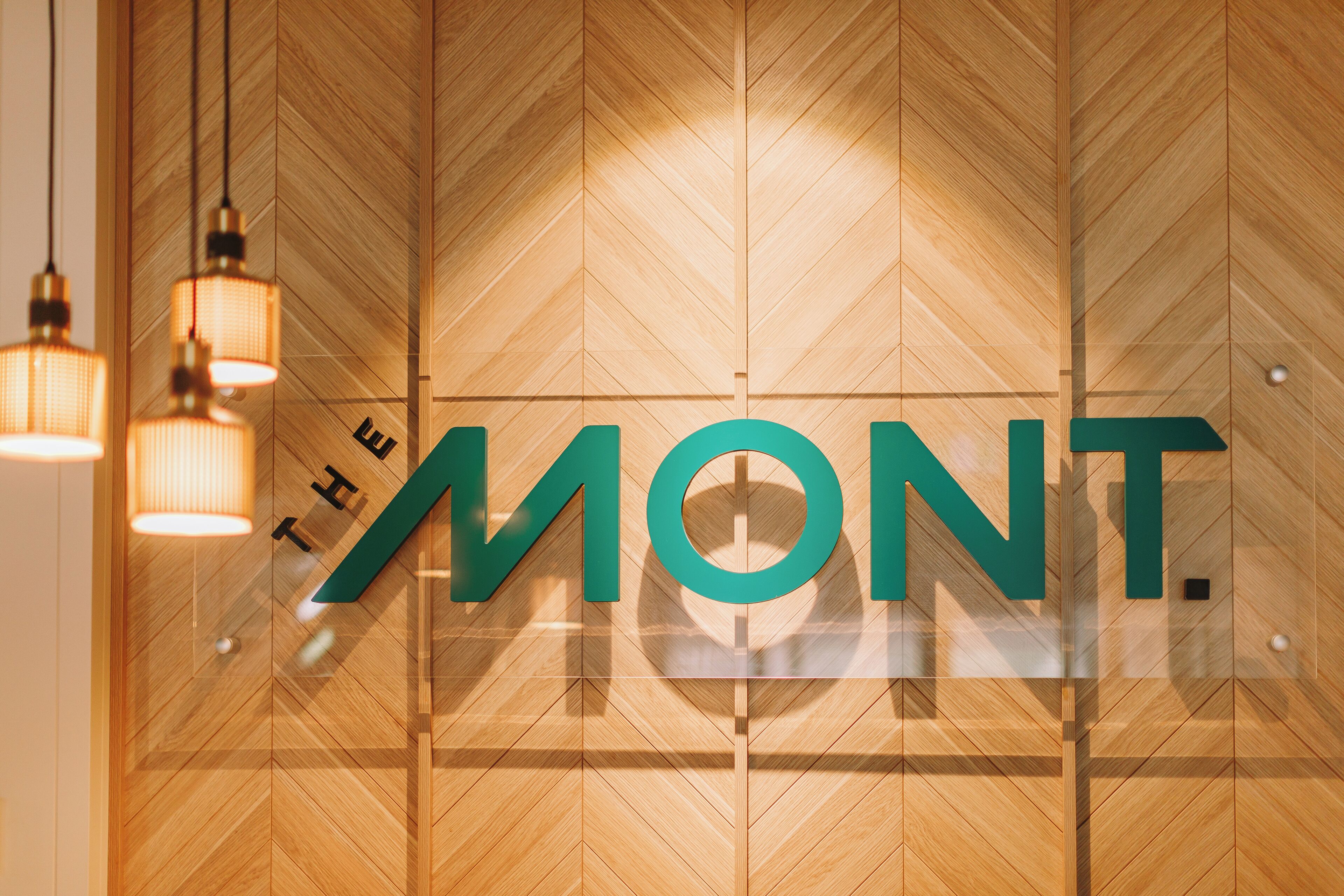 A wooden wall with the text "THE MONT." in large letters.