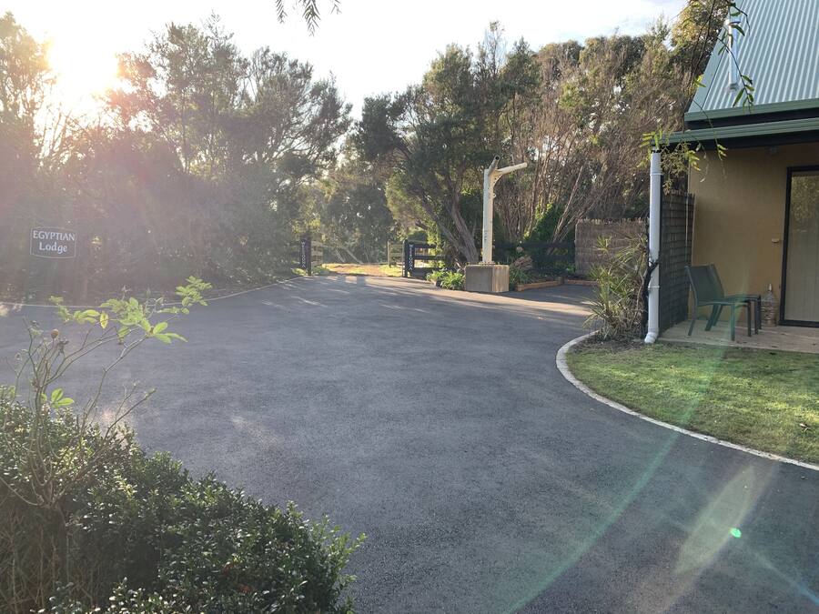 A paved driveway leading to a building with a sign reading "EGYPTIAN Lodge".