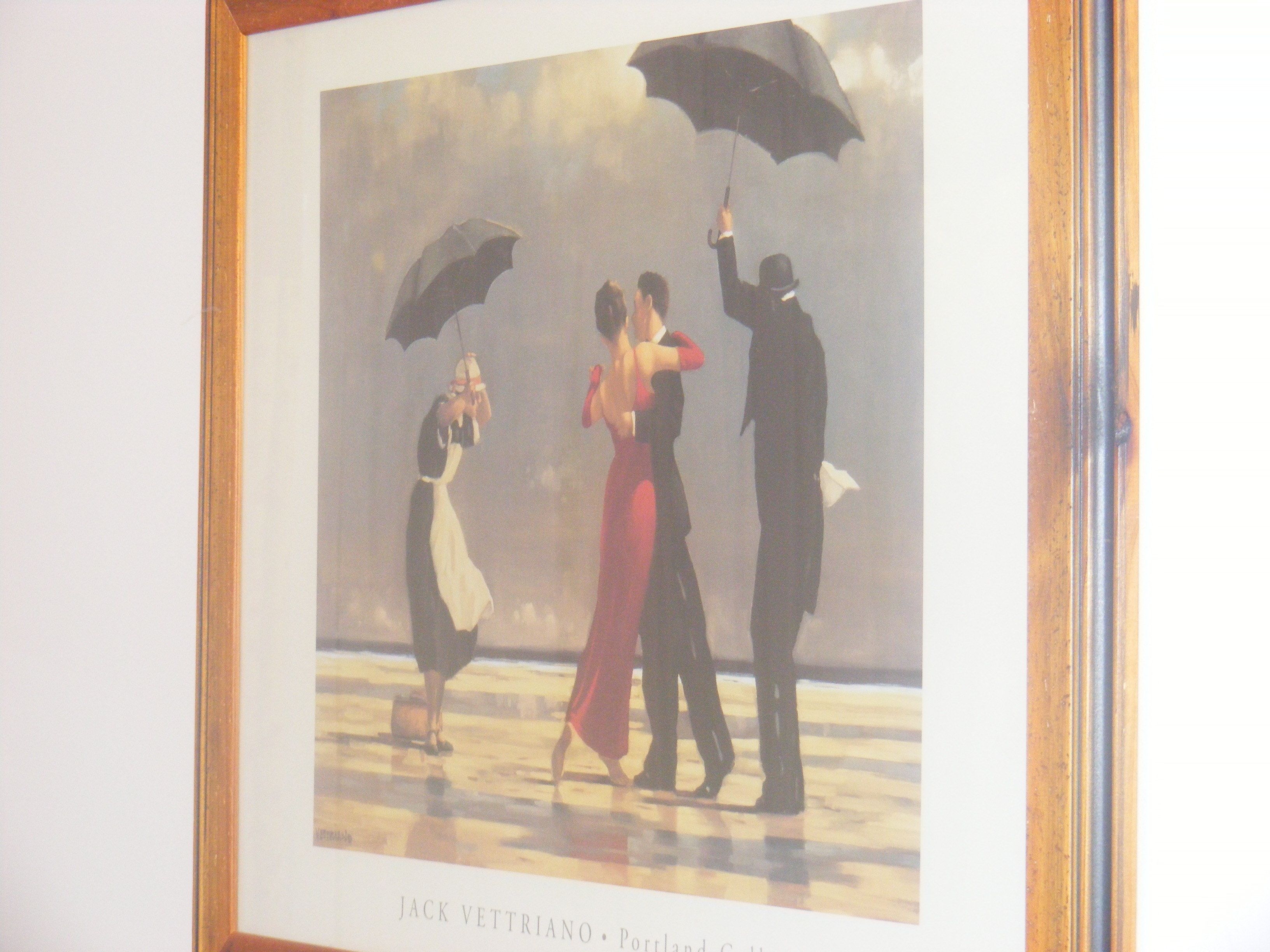 A framed artwork of a couple dancing with an umbrella, titled "Jack Vettriano - Portland".