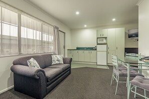 Standard Suite, 1 Bedroom | Living area | 18-inch TV with cable channels