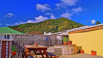 Enjoy a peaceful outdoor space with a picnic table and lush greenery.