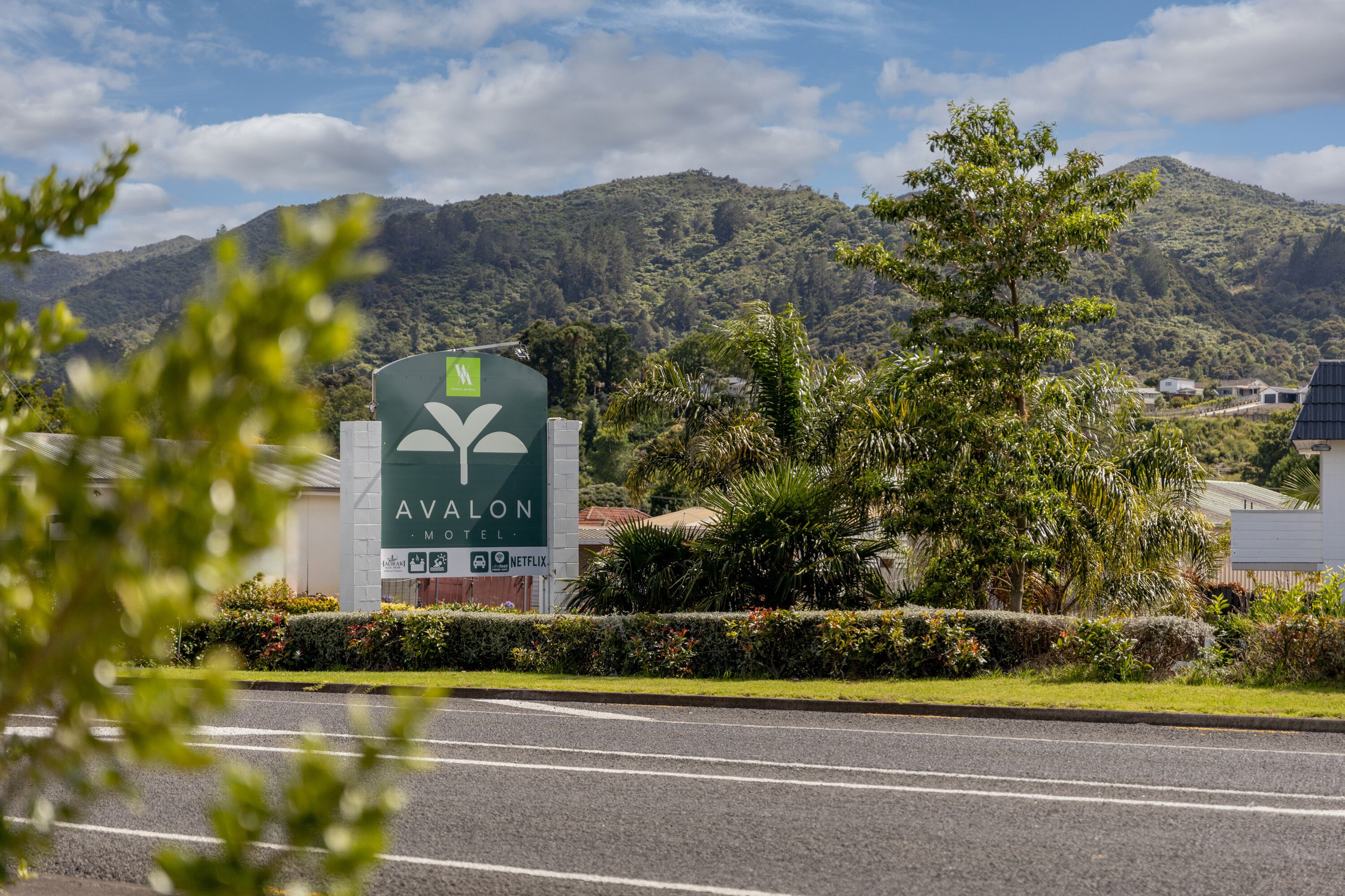 A hotel sign with the name "Avalon Motel" and logos for "KTV" and "Netflix."