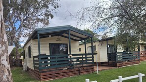 A mobile home with a porch, a covered area, and a fenced yard. - Bonnie Doon Caravan Park (Bonnie Doon)