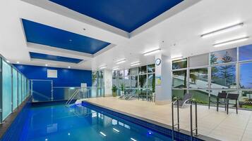 Relax by the pool, surrounded by lush views and comfortable lounge seating.