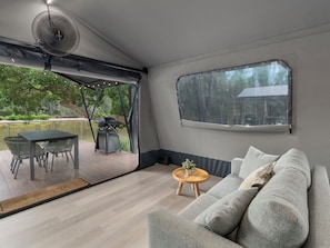 Deluxe Creekfront Safari Tent  No Ensuite | Living area | 32-inch flat-screen TV with satellite channels, ping pong - Big4 Nelligen Holiday Park (Nelligen)