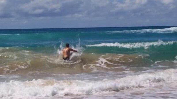 A person in the ocean with waves.