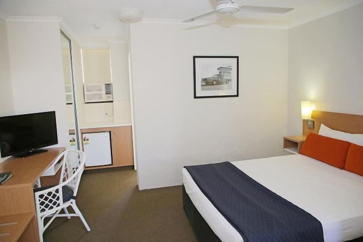 Desk, iron/ironing board, bed sheets