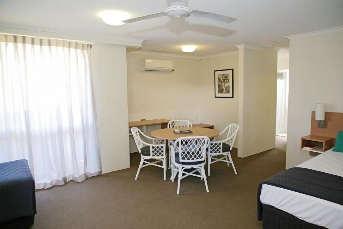 Desk, iron/ironing board, bed sheets