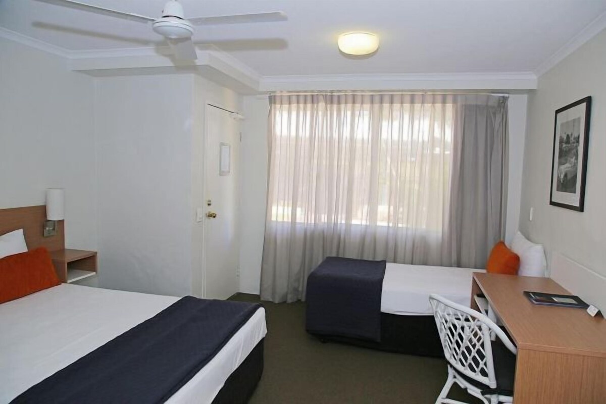 Desk, iron/ironing board, bed sheets