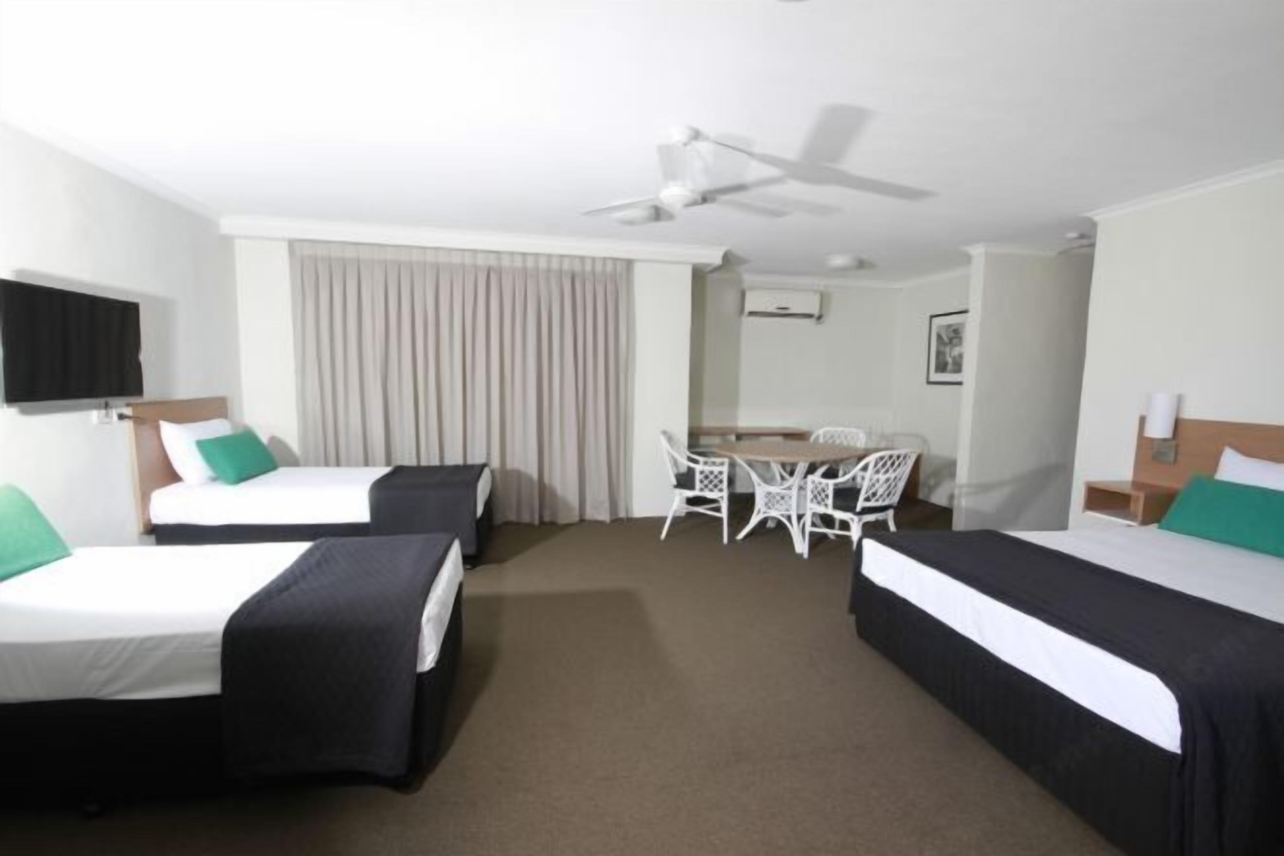 Desk, iron/ironing board, bed sheets
