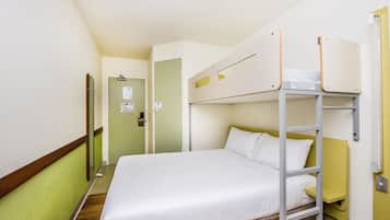 A bunk bed room with a wooden floor, a green wall, and a door with a sign.