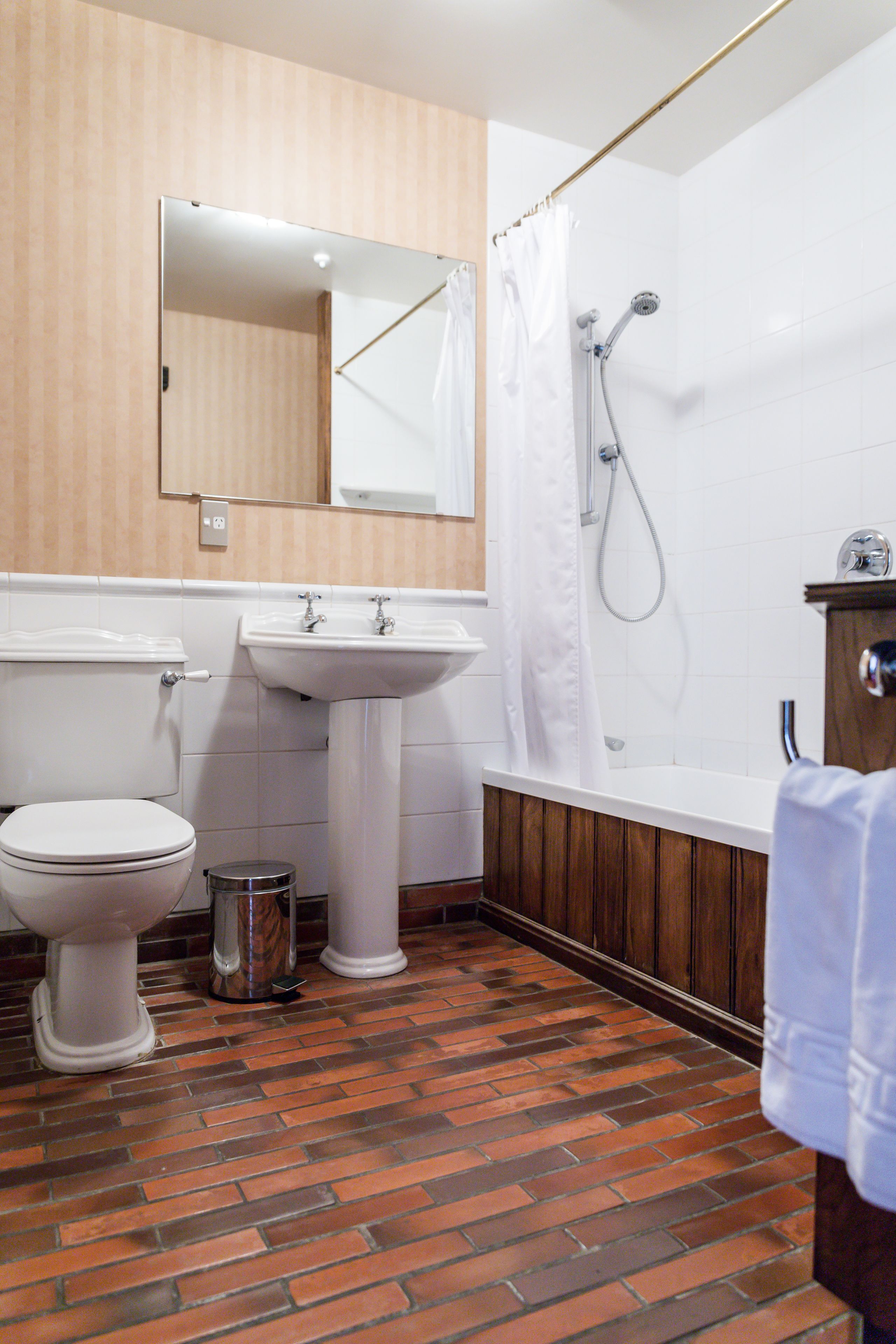 A bathroom with a toilet, sink, and shower.