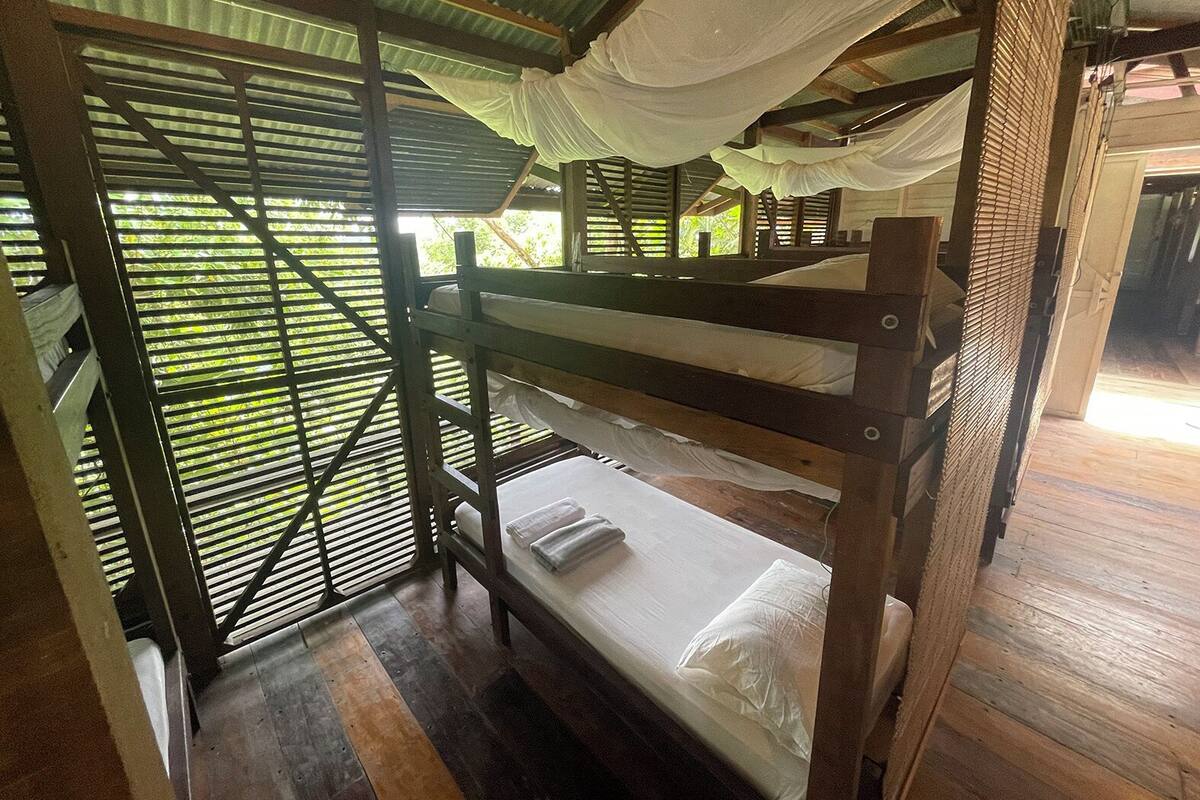 A bunk bed room with a metal frame and a canopy.