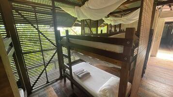 A bunk bed room with a metal frame and a canopy.