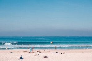 Beach nearby, white sand, beach umbrellas, beach towels