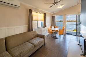 Waterfront Spa Cabin | Living area | Flat-screen TV, DVD player