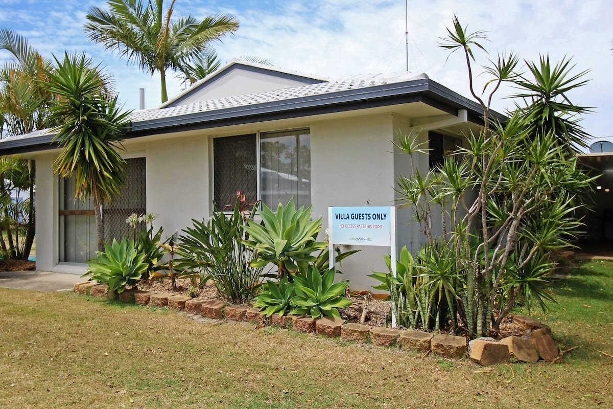 A villa with a sign indicating 'Villa Guests Only' and a no access past this point.