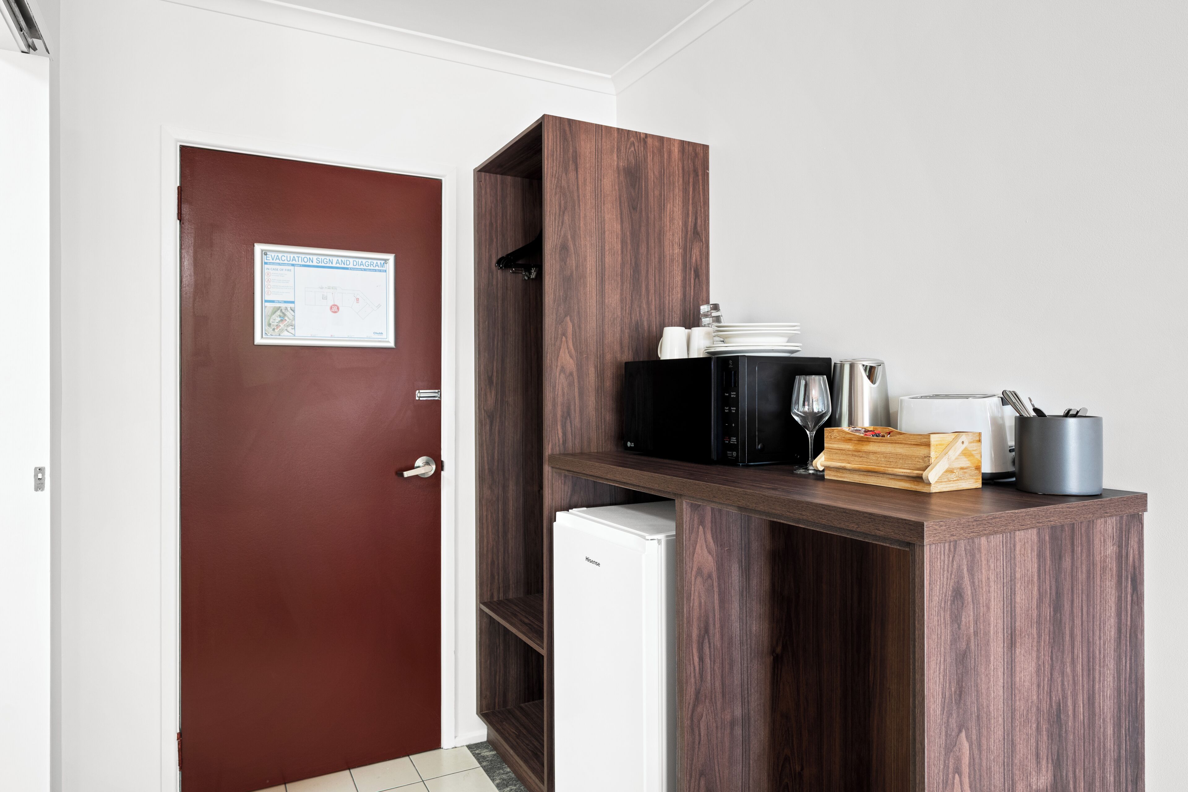 A kitchenette with a microwave, toaster, and coffee maker.