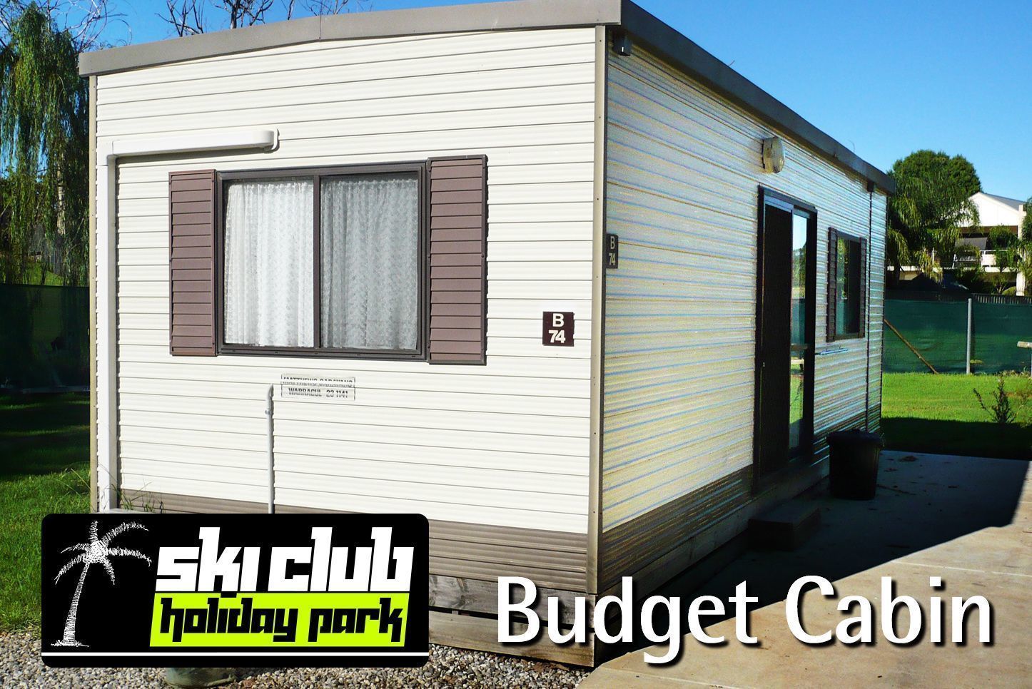 A budget cabin with a sliding door, a window with shutters, and a small porch area.