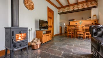 Romantic Armoury Cottage (Your own Private Cottage) | Living area | Flat-screen TV, fireplace