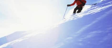 A person skiing on a snowy slope.