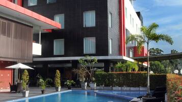 Alberca al aire libre y camastros