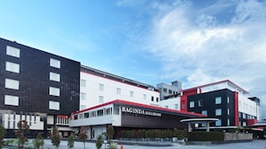 Experience the sleek, contemporary design of this modern building, featuring a prominent ballroom entrance and expansive windows.