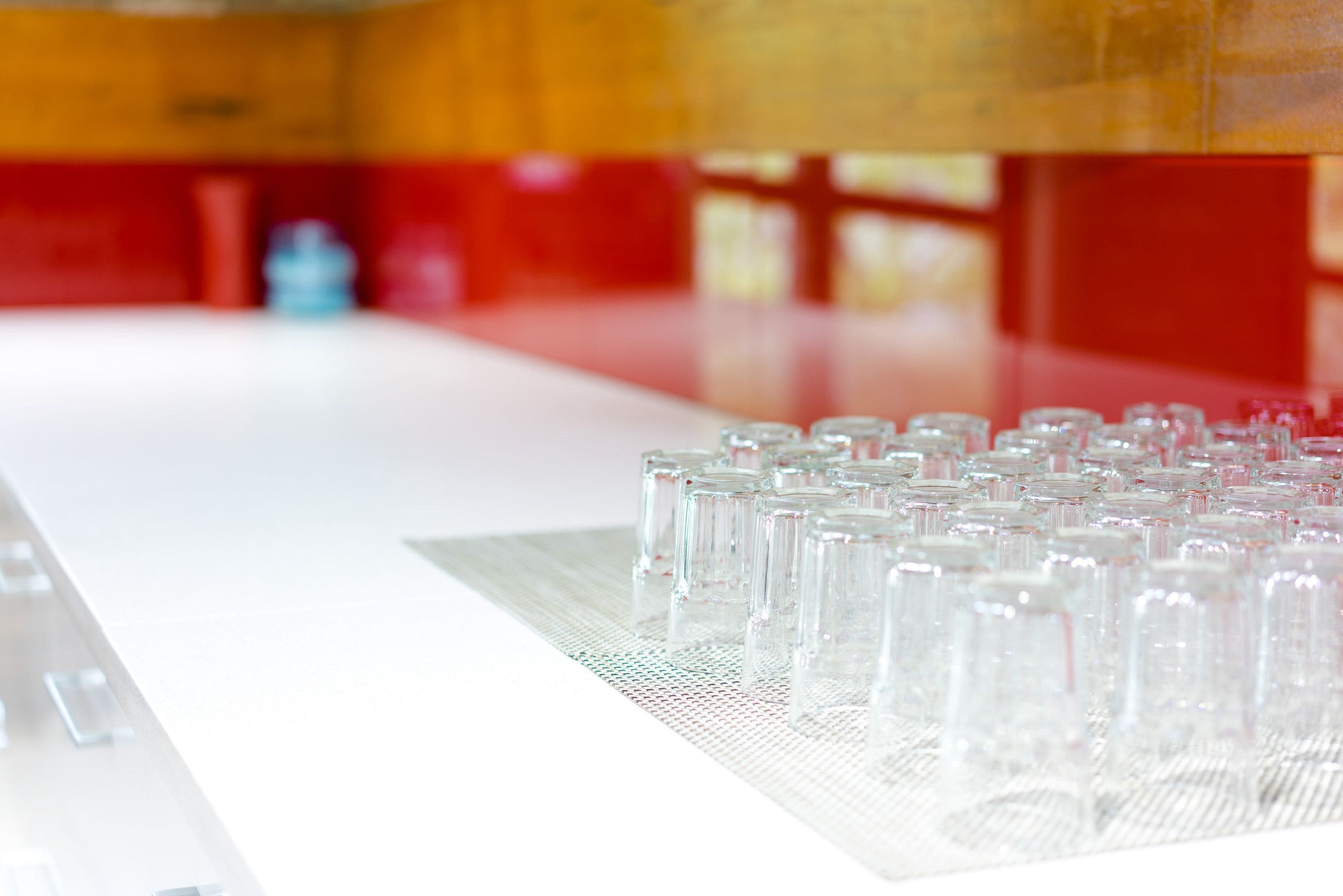 A laboratory setting with multiple clear test tubes arranged on a white surface.