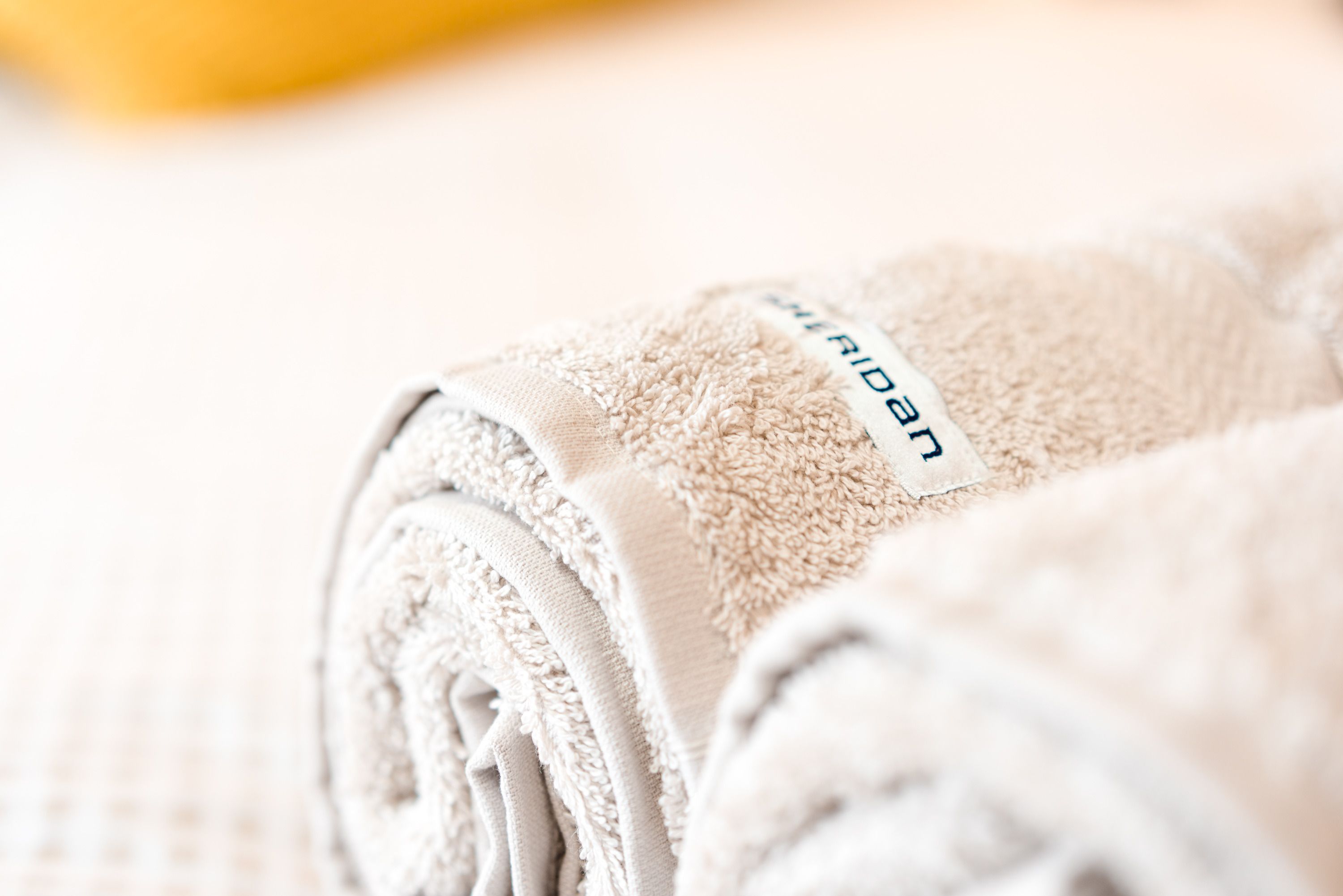 A neatly folded towel with a tag labeled "RUDINAN".