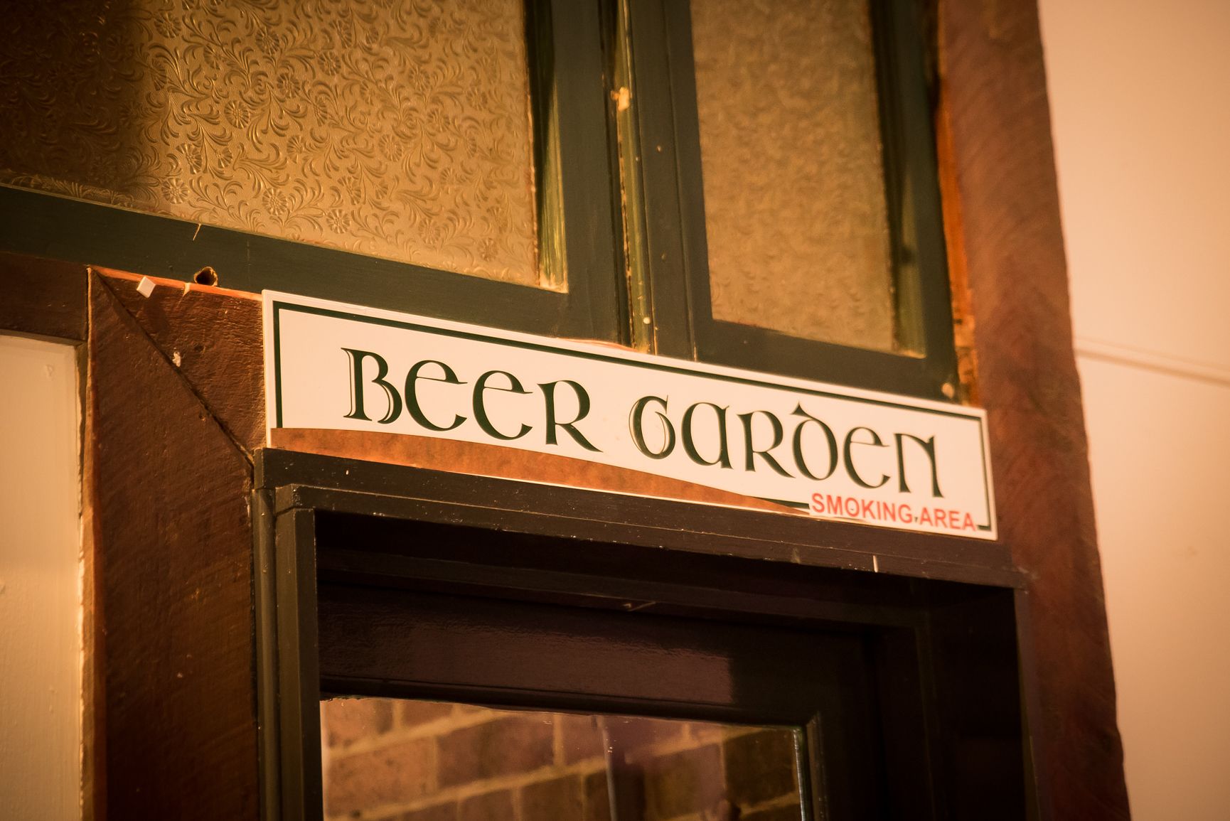 A sign for "Beer Garden" with a "Smoking Area" label.