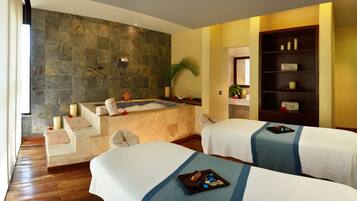 Relax in this serene hotel room with a bathtub, two beds, and a cozy atmosphere.