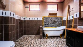 A bathroom with a bathtub, a toilet, and a shower.