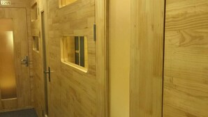 A wooden hallway with a door marked 2205, a window, and a door handle. - Box Hotel (Hanoi)