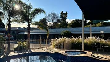 Alberca al aire libre y camastros