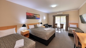 A hotel room with two beds, a desk, a chair, and a TV. - Top of the Town Motel & Apartments (Benalla)