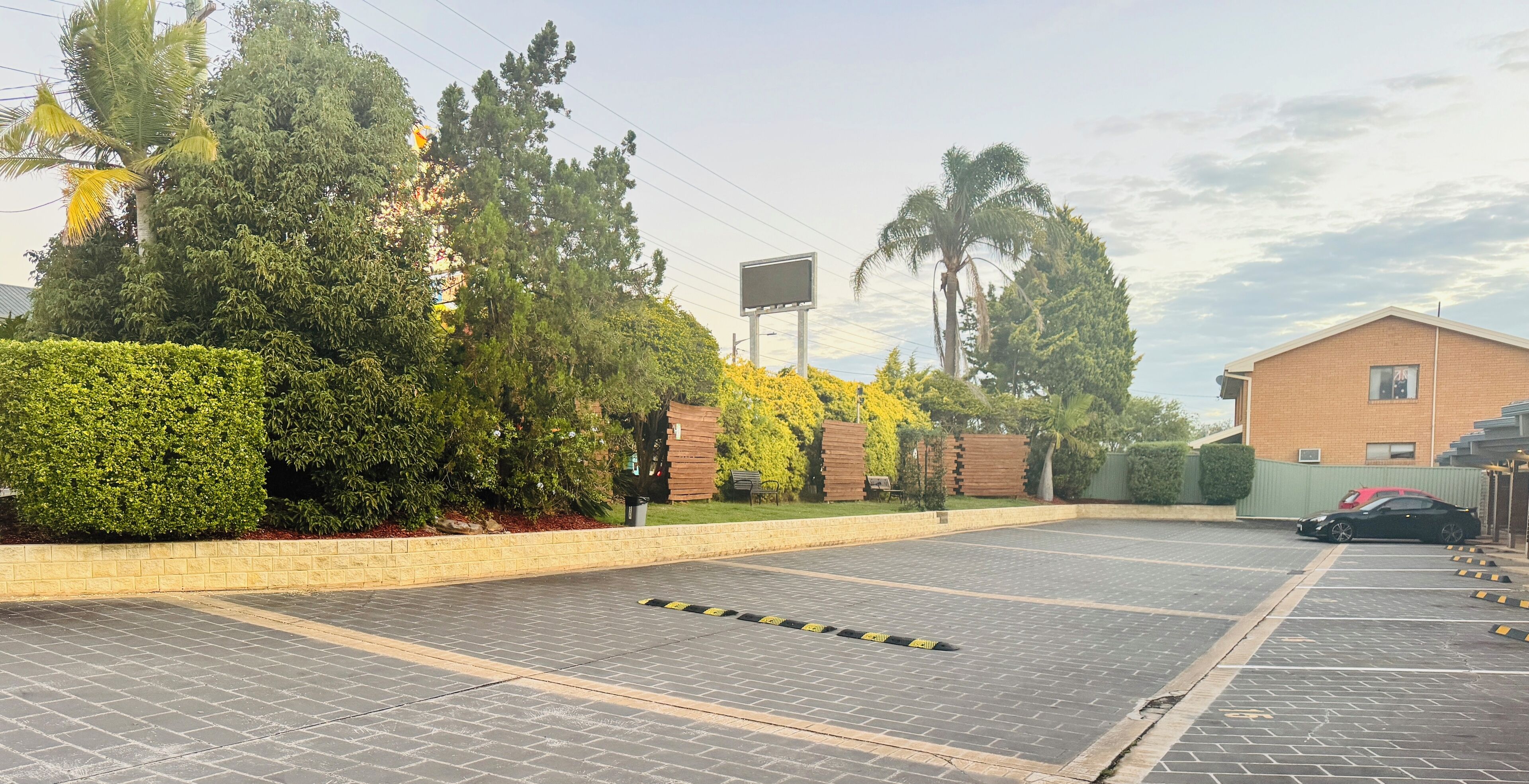 A parking area with paved surfaces and yellow caution tape.