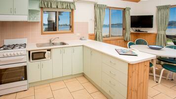 Bungalow | Private kitchen | Full-sized fridge, microwave, stovetop, electric kettle