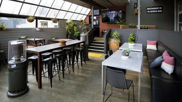 A modern interior with a bar area, seating, and a staircase leading to an upper level. - Doctor Syntax Hotel (Sandy Bay)