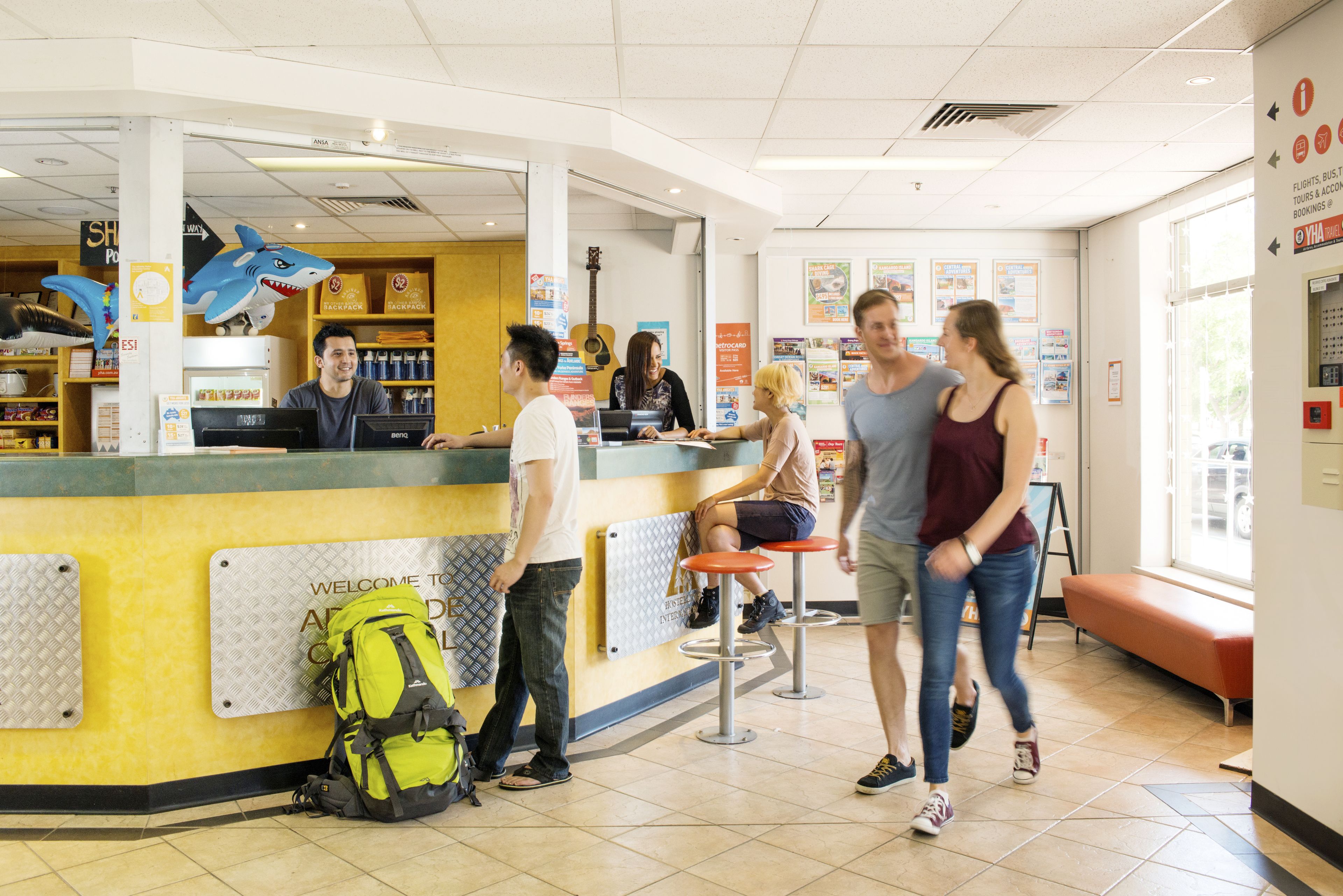 A reception area with a counter, a guitar, and a seating area with a bench.