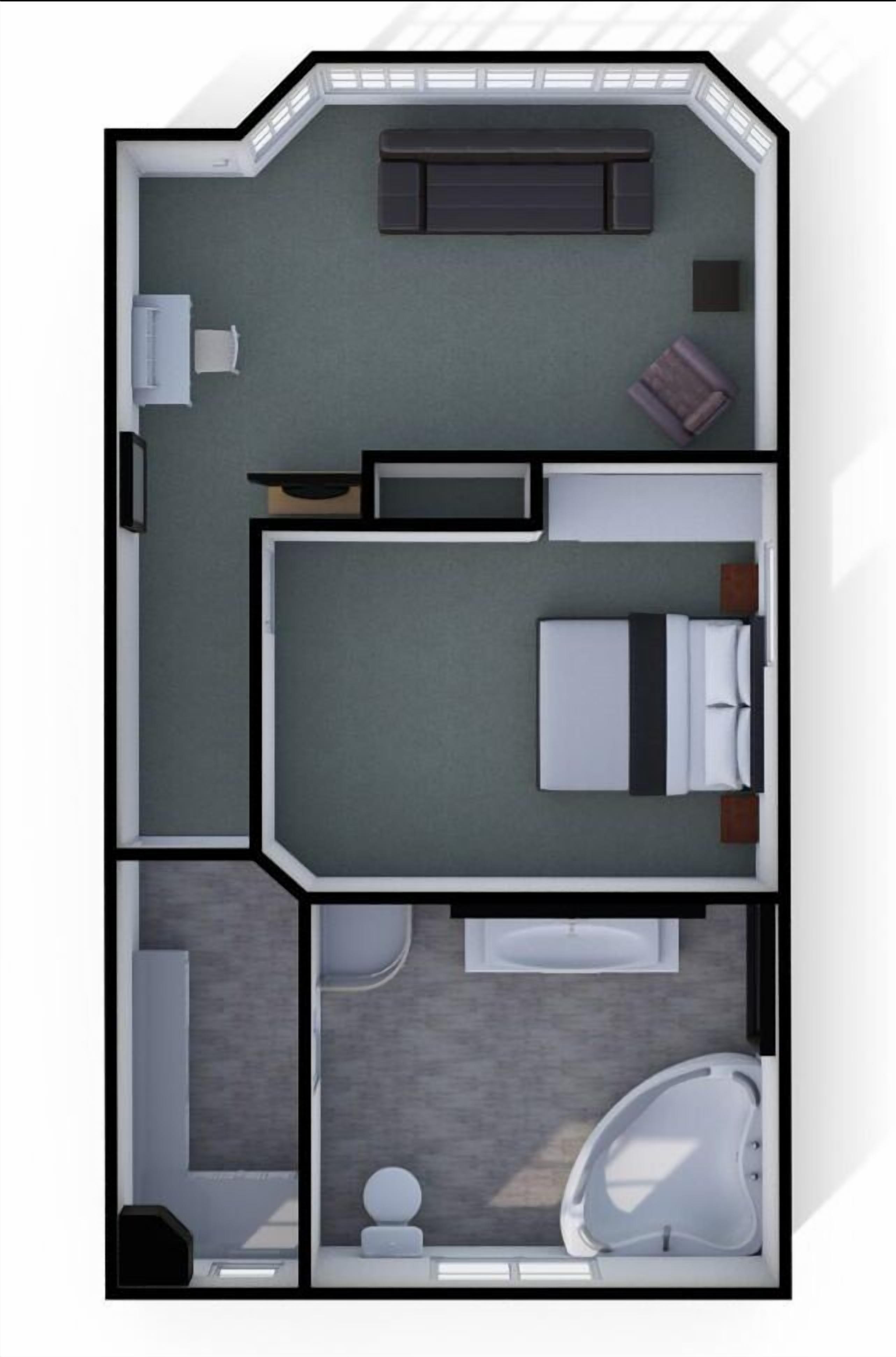Planta de quarto de hotel com cama, área de estar, banheiro e uma pequena cozinha.