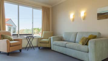 Standard Room, Non Smoking, Kitchenette (One bedroom unit) | Living area | Smart TV